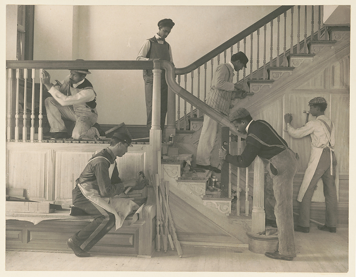 Students at work on a house built largely by them, 1899 or 1900. Creator: Frances Benjamin Johnston. Students at work on a house built largely by them, 1899 or 1900. Young African American men, training in woodworking, building a stairway in a house in Hampton, Virginia.