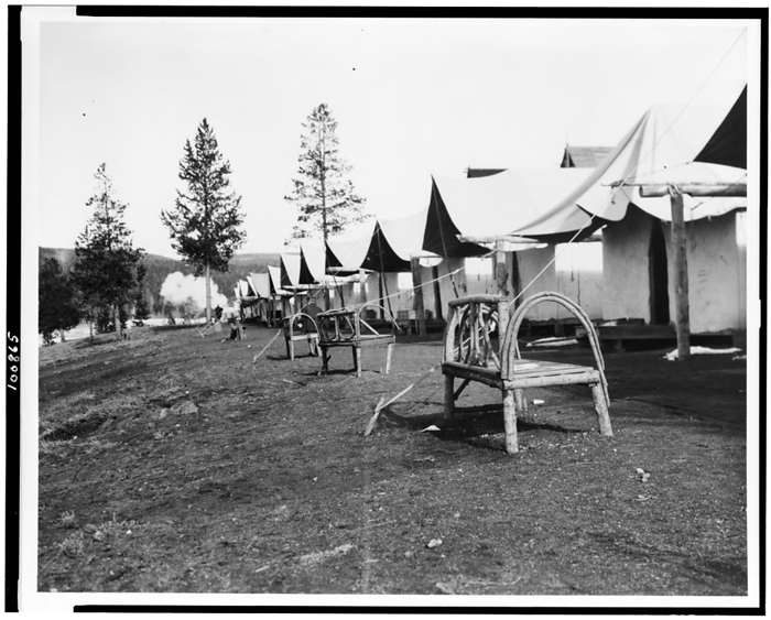 Tourist accommodations in Upper Geyser Basin, Yellowstone Park, 1903. Creator: Frances Benjamin Johnston. Tourist accommodations in Upper Geyser Basin, Yellowstone Park, 1903. Tents and rustic log benches.  Wyoming .