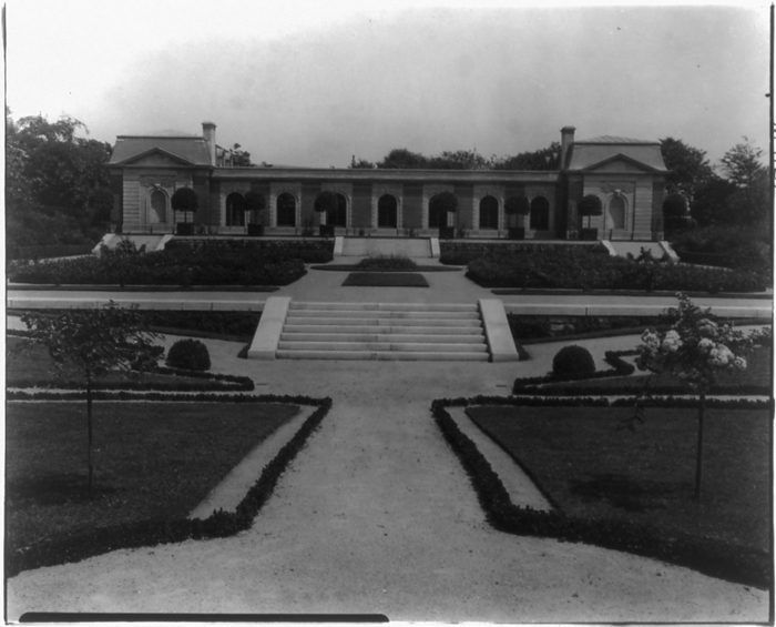 Hamilton Rice home, Newport, Rhode Island, exterior view, between 1917 and 1927. Creator: Frances Benjamin Johnston. Hamilton Rice home, Newport, Rhode Island, exterior view, between 1917 and 1927. The Miramar neoclassical mansion was designed by Horace Trumbauer for heiress and philanthropist Eleanor Elkins Widener and her husband George Widener. After George died aboard the RMS Titanic in 1912 Eleanor married again, and Miramar was used as a summer residence by her and her second husband, geographer and explorer Alexander H. Rice Jr. The gardens were created by Jacques Gr  xe9 ber.