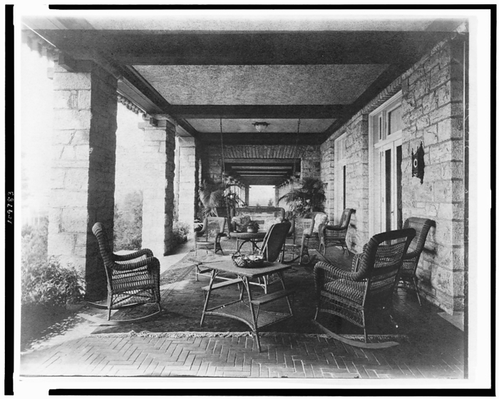 Porch of E.C. Converse house, with wicker furniture, Greenwich, Connecticut, 1908. Creator: Frances Benjamin Johnston. Porch of E.C. Converse house, with wicker furniture, Greenwich, Connecticut, 1908. The Conyers Farm estate, designed by Donn Barber c1904, was owned by businessman Edmund C. Converse.