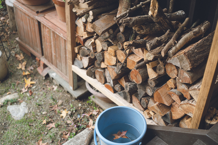 Firewood stocked for home fireplaces in outdoor wood storage areas