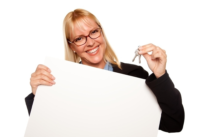 Attractive blonde holding keys and blank white sign isolated on a white background, Photo by Andy Dean