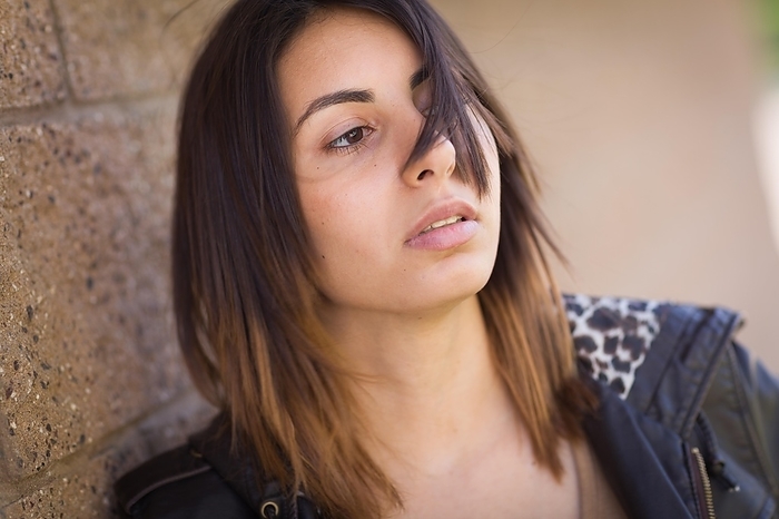 Beautiful meloncholy mixed-race young woman portrait outside, Photo by Andy Dean
