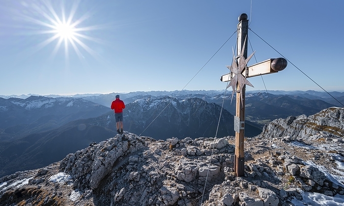 Mountaineer at the summit of the Guffertspitze, summit with summit cross, sun star, in autumn, Brandenberg Alps, Tyrol, Austria, Europe, Photo by Mara Brandl