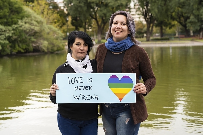 Love is never wrong. Cheerful queer couple holding a message supporting the LGBT community, Photo by Mariano Gaspar