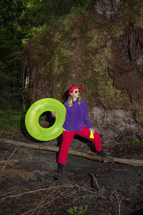 Woman wearing sunglasses holding inflatable ring