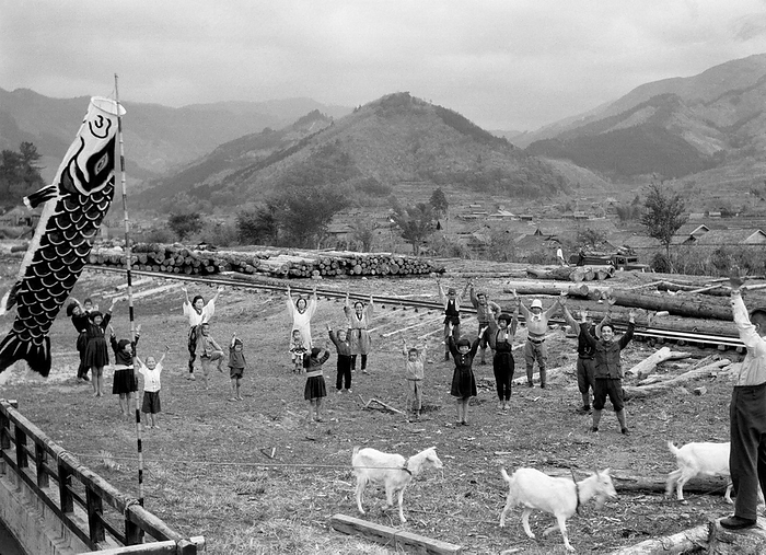 Life in Wartime  May 1943  This village is literally a mountain village. Old men and women protect the mountains in place of men who have been called to duty. They cultivated land to increase the yield of vegetables, and kept goats to supplement milk for babies. In addition, if a member of the mutual aid association of forestry companies becomes ill, the association pays a percentage of the cost of treatment, and all villagers are healthy. People cheerfully doing exercises in Nishitani Village, Hyogo Prefecture, photographed in May 1943 Place names and other names used at the time, now Shiso City  2010, Osaka PDB Center 