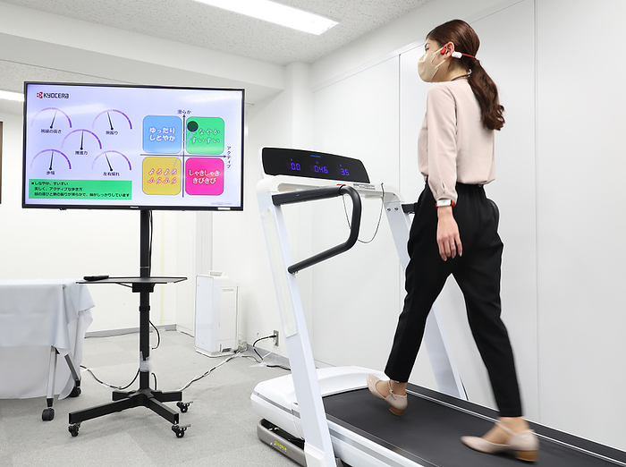 Three systems of  human extension  technology presented by Kyocera October 13, 2022, Tokyo, Japan   Japan s electronics giant Kyocera employee walks on a treadmill to demonstrate the company s walk sensing and coaching system with three wearable sensors of earphone, bracelet and anklet in Tokyo on Thursday, October 13, 2022. The walk sensing system measures posture with tiny sensors and provide real time diagnosis and coaching through an earphone.       Photo by Yoshio Tsunoda AFLO  