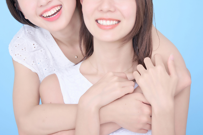 Women showing bright, white teeth.