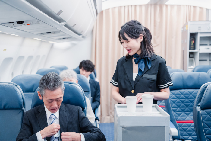 Japanese passengers on board an airplane (People)