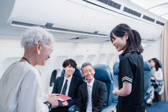 Japanese passengers on board an airplane (People)