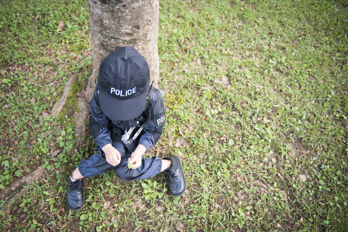 Girl in police costume sitting and taking a break