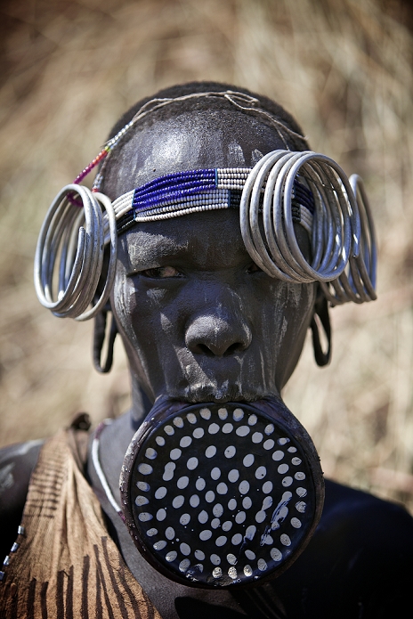 People of the World Ethiopia The mark of the Mursi people is a plate on their lips  2010  Woman from the Mursi tribe in South Ethiopia, wwar very large clay lipplates. Also they decorate their faces and heads with various rings and beads, Omo Valley, Ethiopia,2010