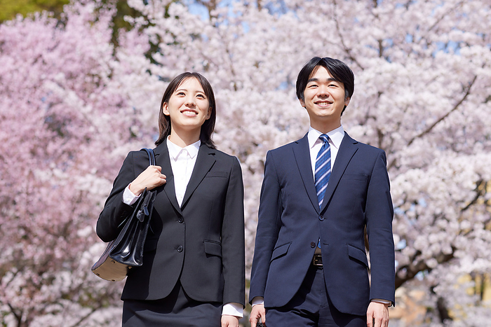 Japanese business men and women commuting with cherry blossoms
