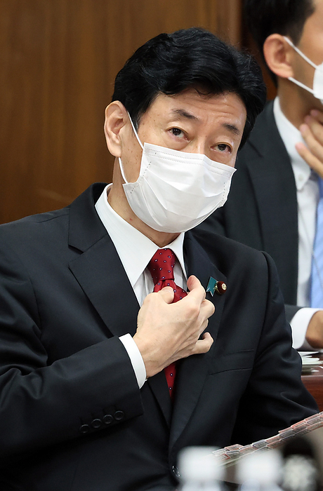 Japanese Economy, Trade and Industry Minister Yasutoshi Nishimura attends Lower House s economy and industry committee session November 2, 2022, Tokyo, Japan   Japanese Economy, Trade and Industry Minister Yasutoshi Nishimura adjusts his tie as he listens to a question at Lower House s economy and Industry committee session at the National Diet in Tokyo on Wednesday, November 2, 2022. Nishimura asked on November 1 households and businesses to save electricity this winter to avoid power crunch.     Photo by Yoshio Tsunoda AFLO 