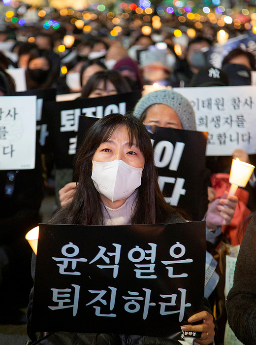 Mourners demand the resignation of the world s most disliked President Yoon Suk Yeol People mourn for the victims of the Halloween crowd crush, November 5, 2022 : People participate in a candlelight vigil held to mourn for the victims of the Halloween crowd crush in Seoul, South Korea. Thousands of people demanded the resignation of South Korean President Yoon Suk Yeol to take his responsibility for the catastrophe in Itaewon district where the Halloween crowd crush killed 156 people and injured 197. Korean letters on pickets read,  Yoon Suk Yeol resign ,   Yoon Suk Yeol s  Resignation is the remembrance  for the victims   and   Yoon Suk Yeol s  Resignation is the peace  between the two Koreas  .  Photo by Lee Jae Won AFLO   SOUTH KOREA 