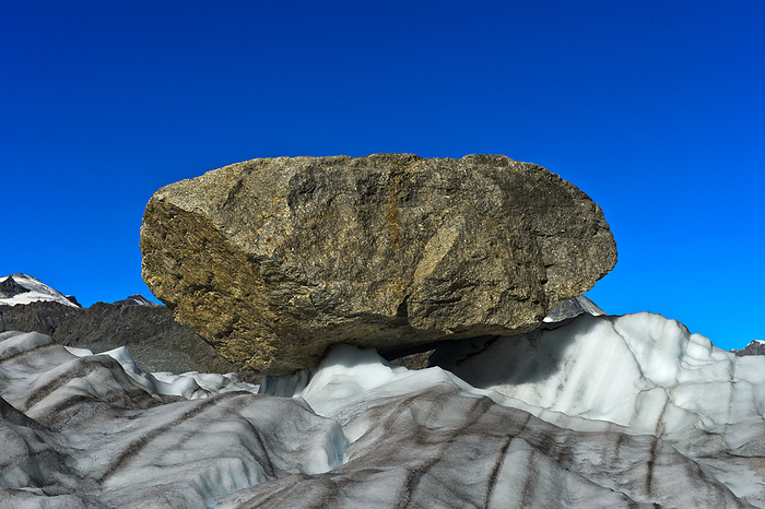 Big rock, glacial erratic, laying on the Gorner Glacier, Zermatt, Valais, Switzerland