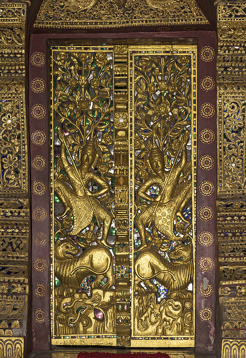 Splendid cladding of the entrance door to the temple Wat Pa Phai, Luang Prabang, Laos