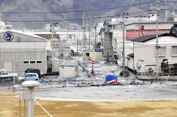 Cars washed away by the tsunami and flooded houses in Kesennuma City, Miyagi Prefecture, Japan. The Great East Japan Earthquake. Cars washed away and houses flooded by the tsunami in Shiomi Town, Kesennuma City, Miyagi Prefecture. The massive earthquake that struck the Tohoku region, the Kanto region, and the Tokyo metropolitan area on the afternoon of March 11, 2011, registered a magnitude of 8.8, the largest earthquake ever recorded in Japan, and triggered a massive tsunami that wiped out towns without leaving any trace.  Tsunami surging inland. published by Yomiuri KODOMO newspaper on March 7, 2019.