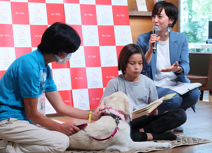 A promotional event of Reading Dogs for children therapy November 10, 2022, Tokyo, Japan   Japanese animal welfare activist Christel Takigawa  R , wife of lawmaker Shinjiro Koizumi demonstrates the  Reading Dogs , reading books to dogs which help children therapy at a promotinal event at the Tsutaya book store in Tokyo on Thursday, November 10, 2022.     Photo by Yoshio Tsunoda AFLO 