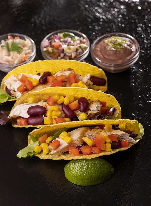three Mexican tacos on slate three Mexican tacos on slate