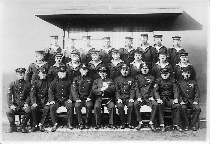 Japanese Imperial Navy Cadets   1940s Japan   Japanese Navy Cadets    Uniformed cadets and officer of the Imperial Japanese Navy in Yokosuka, Kanagawa Prefecture.  Based on the insignia, this was photographed in November 1942 at the earliest.  20th century vintage gelatin silver print.  Photo by MeijiShowa AFLO