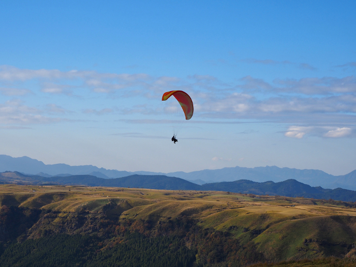 Paraglider flying over the caldera of Aso