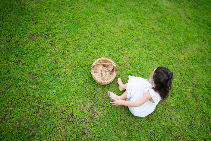 Barefoot girl playing with a basket