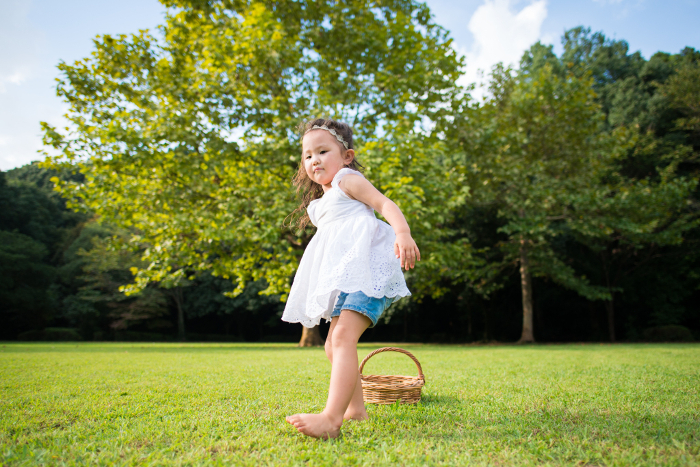 Barefoot girl playing with a basket