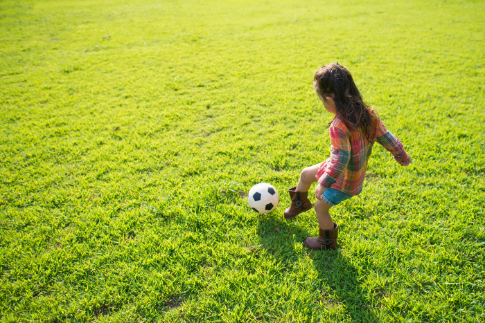Girl playing with soccer ball