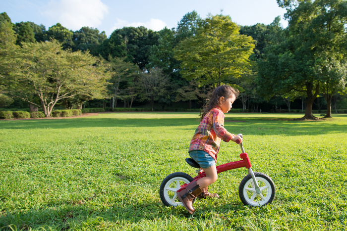 Girl playing with bicycle