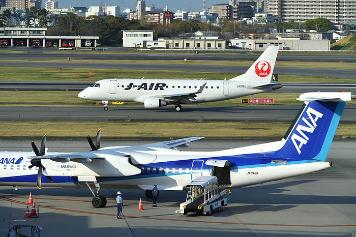 ANA Wings  Bombardier aircraft parked in Hyogo Prefecture and J AIR s Embraer 170 on the ground Taken at Osaka International Airport