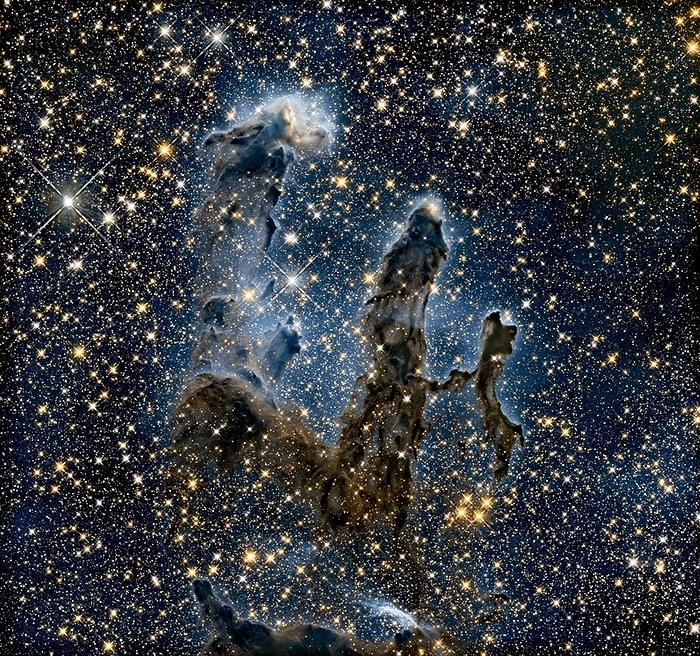 Pillars of Creation, infrared HST image Pillars of Creation. Infrared Hubble Space Telescope  HST  image of the cold molecular pillars in the Eagle Nebula known as the  Pillars of Creation . The near infrared light gathered here penetrates much of the gas and dust, revealing stars behind the nebula as well as hidden inside the pillars. Some of the gas and dust clouds are so dense that even the near infrared light cannot penetrate them. New stars embedded in the tops of the pillars are seen as bright sources that are unseen in the visible image. The ghostly bluish haze around the dense edges of the pillars is material getting heated up by nearby  unseen  young, massive stars and evaporating away into space. This region is 6500 light years away, in the constellation of Serpens. Image data obtained in 2014 by the HST s Wide Field Camera 3  WFC3 . Image published in 2015., by NASA, ESA, and the Hubble Heritage Team  STScI AURA  SCIENCE PHOTO LIBRARY