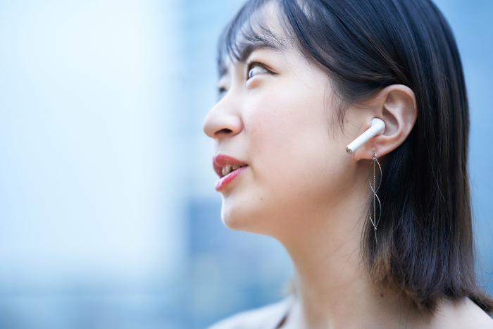 Young Japanese woman wearing earphones.