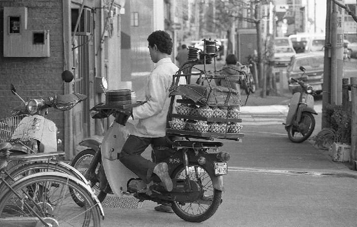 Delivery Service  May 1982  May 1982, Tokyo, Japan   Motorcycle and hi tech device take over Japan s traditional service of food delivery by noodle shop boys who used to maneuver their bicycles skillfully while carry on their shoulders stacks of noodle and rice containers.   Photo by Natsuki Sakai AFLO  AYF  mis 