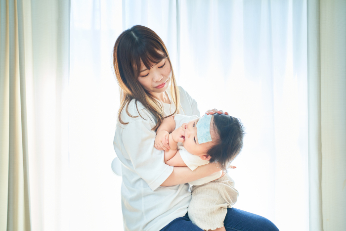 Japanese toddler with fever and mother taking care of him (People)