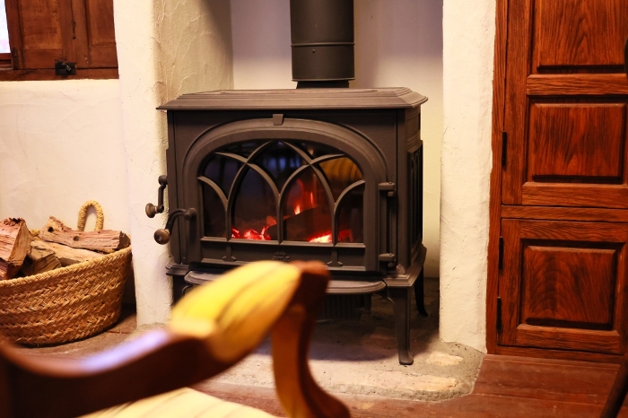 Warm wood stove with fire burning