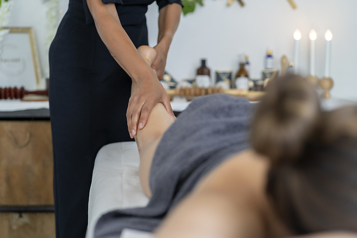 client receiving a relaxing leg massage from a masseuse