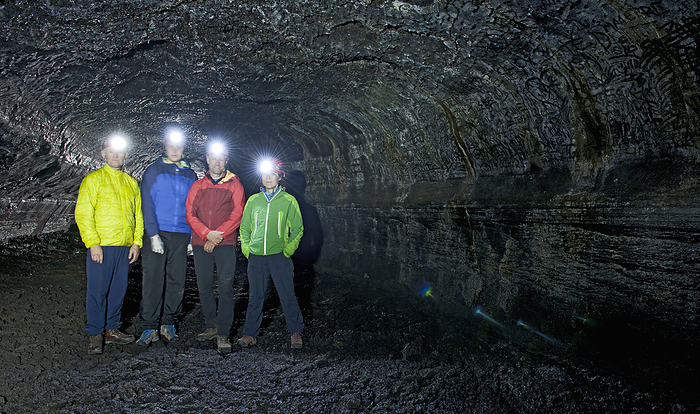 Inside Hlidarrendi cave group of scientists exploring the Leidarendi lava cave in Iceland