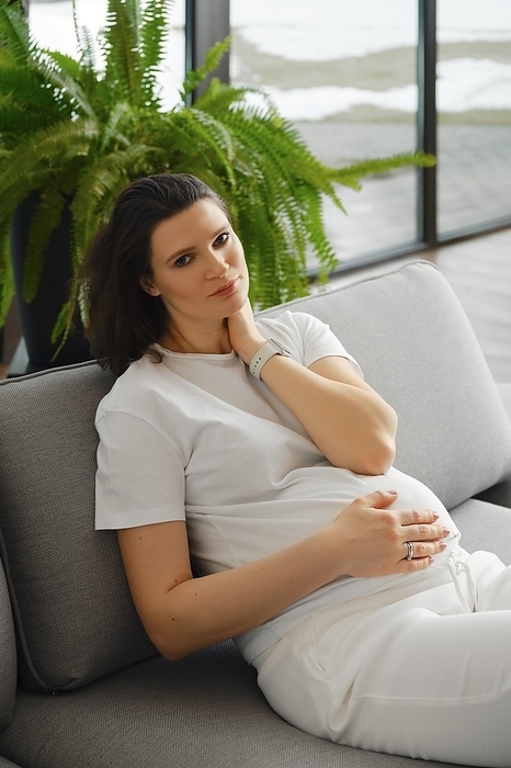 Tired pregnant woman having rest on sofa at home, Photo by Aleksei Isachenko