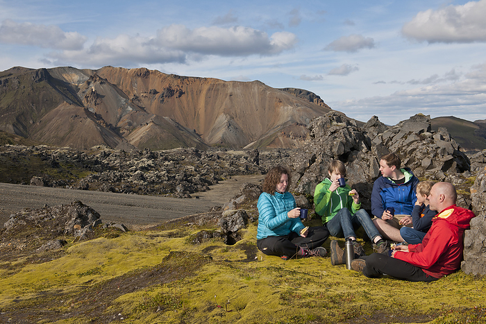 family hiking in Landmanalaugar   a geothermal area in the Icelandic highlands family having a picnic in Landmannalaugar   Iceland