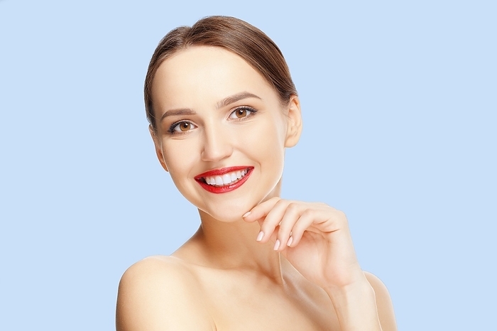 Teeth and skin care. Beautiful young woman with fresh skin and red lips looking straight and demonstraiting healthy teeth, Photo by Aleksei Isachenko