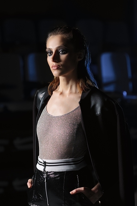 Low key portrait of a girl in dark room. Spotlight lighting fashion model at backstage, Photo by Aleksei Isachenko