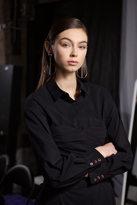 Low key photo of pretty girl in black dress in dressing room near the mirror, Photo by Aleksei Isachenko