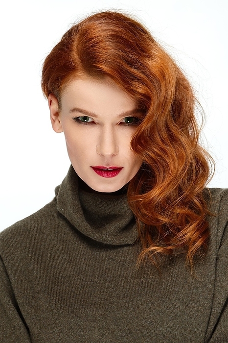 Pretty fashion model with red hair on one side. Red lips and green eyes. Strong face, eyes like gimlets, Photo by Aleksei Isachenko