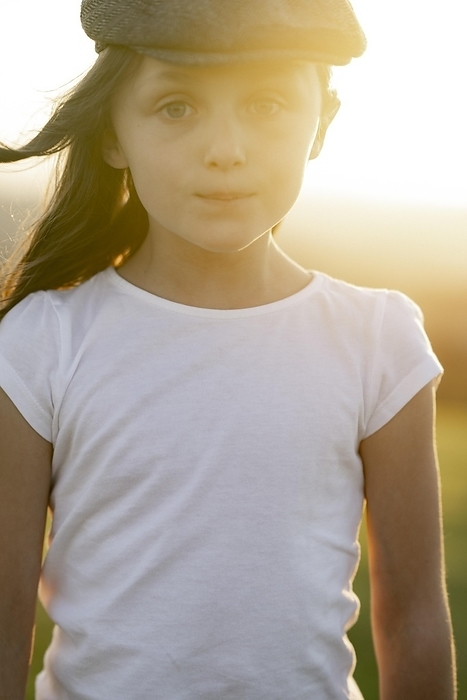 Girl, 8 years, with cap at sunset, Photo by Michaela Begsteiger