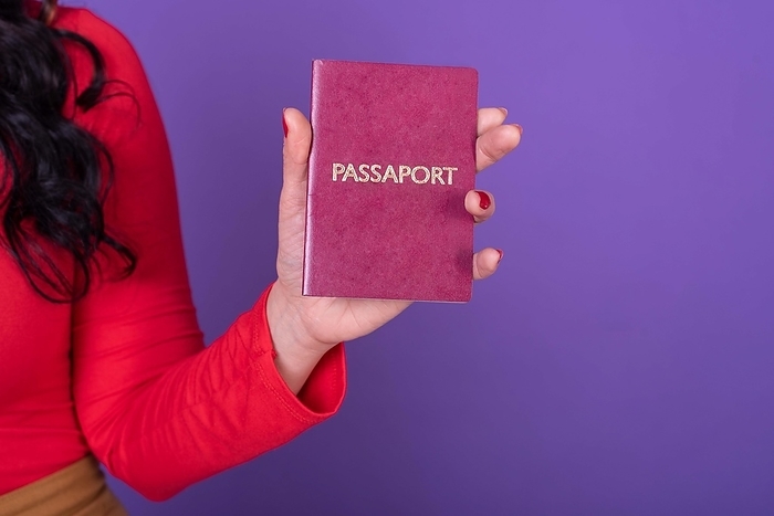 Female hand holding a passport, Photo by Valeria Venezia
