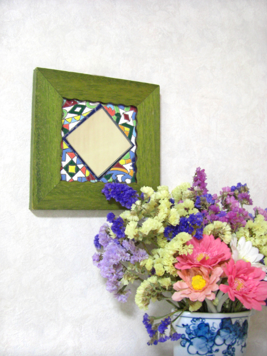 Flowers in vase and wall mirror