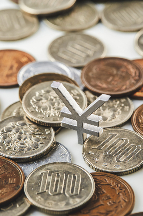 Japanese yen coins and the yen symbol of the Japanese currency sign