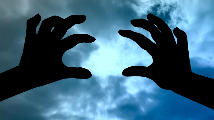 Scary two-handed silhouette_Suspicious sky background_wide